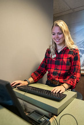 A front desk agent at the Grand Summit Hotel