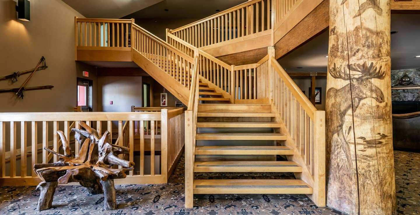 A view of the stairs in the lobby of the Snow Cap Inn at Sunday River