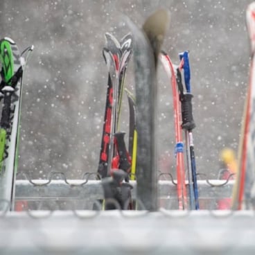 Skis leaning against a ski rack