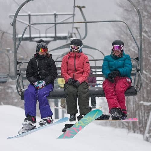 Snowboarders on chairlift