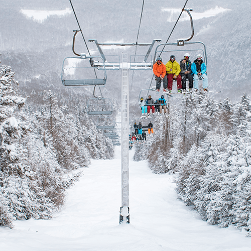 Skiers on chairlift at Sunday River