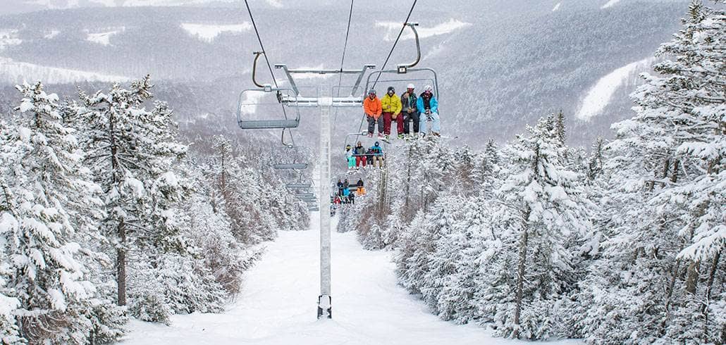 Chairlift above snowy trail