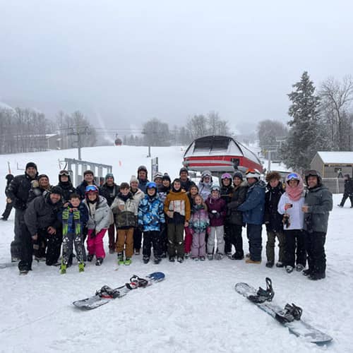 large group of skiers at bottom of south ridge