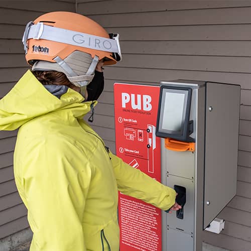 Skier picking up ticket at PUB