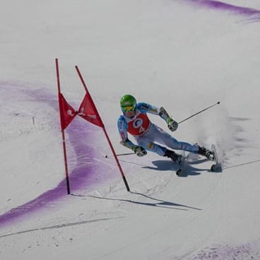 Woman racing down a freshly groomed trail. 