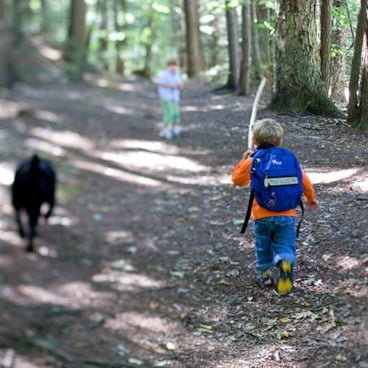 kid hiking up a trail