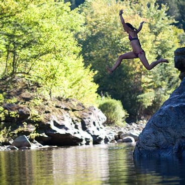 swimmer jumping in lake water